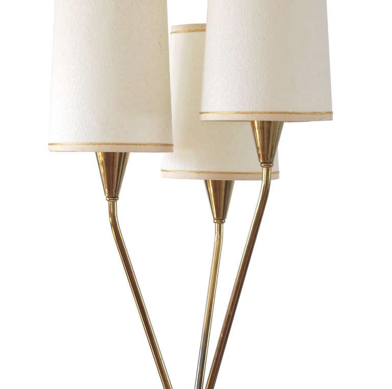 A 1950s floor Lamp by Gerald Thurston for Lightolier comprising a brass plated frame with walnut accents to the legs and three lights controlled by a 3-way switch. Shades are original and in fabulous condition. A Mid Century Modern classic.