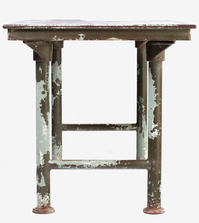 An incredible, all-original, steel foundry table circa 1925 manufactured by Textile Machine Works - - see additional info below. An industrial showstopper with its top beautifully antiqued/distressed with patches of rust stains and marbled remnants