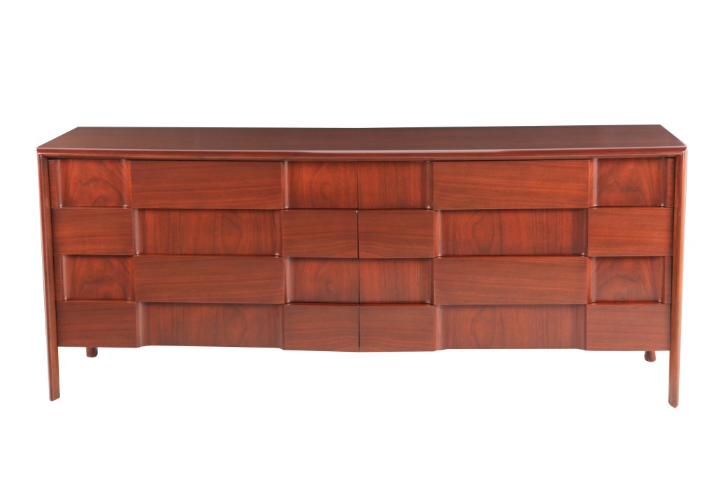 A distinguished 8-drawer dresser or buffet in walnut and birch woods designed by Edmund Spence and made in Sweden. Relief front in a 'checkerboard' pattern with the outer veneers placed on the horizontal and the interior veneers placed on the