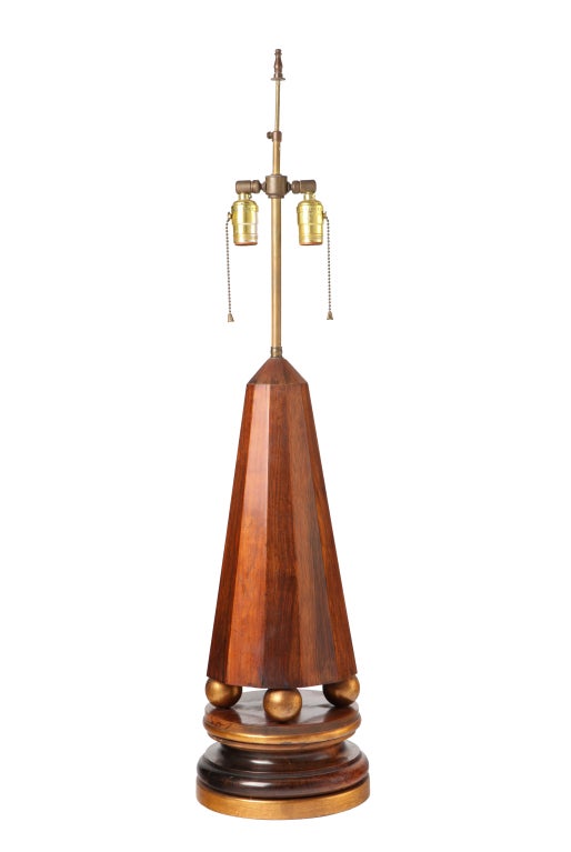 A robust pair of 1940s obelisk-form table lamps executed in rosewood with decorative, gilt wood details. Highest quality, more than substantial in weight and in presence, and in excellent  original condition. **Local delivery within NYC is