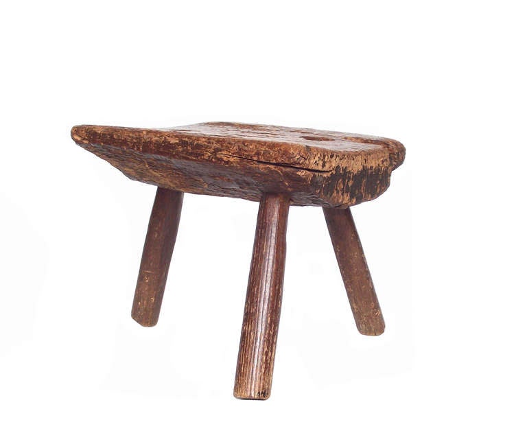 A mid 19th century handcrafted milking stool that came from an old farm in Greenwich, CT. A unique objet d'art with an absolutely beautiful patina and surface texture that only time can produce.