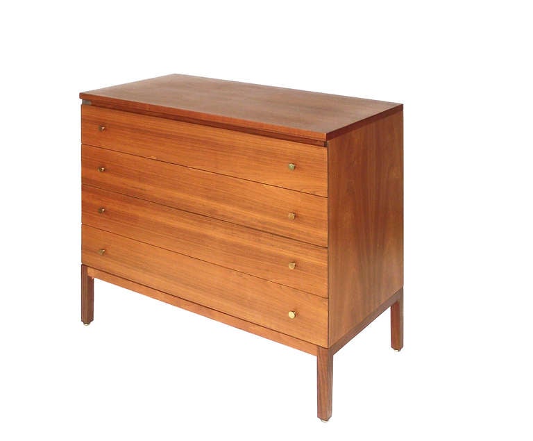 Paul McCobb for Calvin chest / dresser in mahogany over solid ash frame with solid brass drawer pulls. Book matched veneers to top, sides and back in a beautiful honey-brown finish that is all original with a stunning patina. Retains manufacturer's