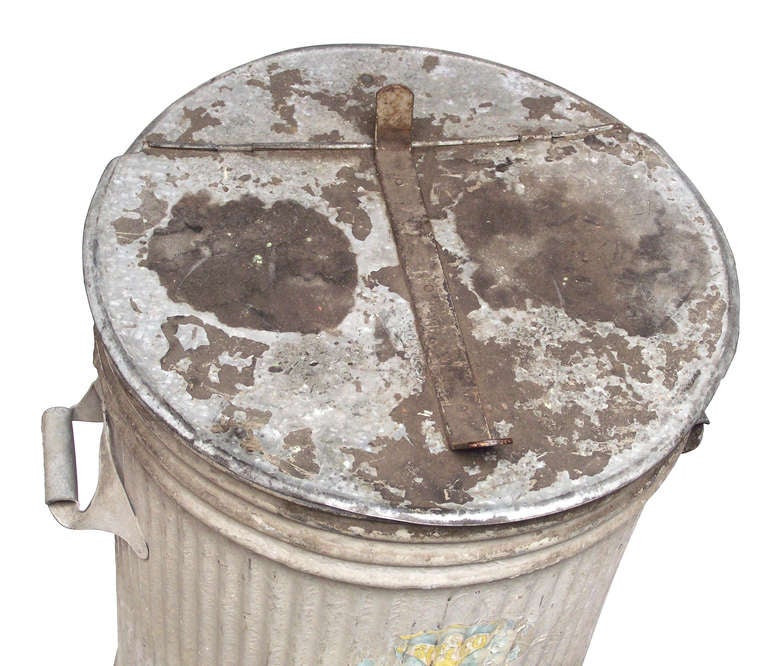A galvanized metal trash can with hinged lid, manufactured by BOYCO of Los Angeles, which was a subsidiary of United States Steel (partial original label to the front of body). BOYCO is well-known amongst auto enthusiasts for the running board gas