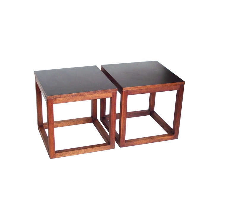 A pair of Minimalist occasional tables in an open cube form with solid teak frames and laminated tops in a slate gray to light black with a faint sheen. Very well-crafted - - take note of the joinery in the last image. Exceptional vintage condition.