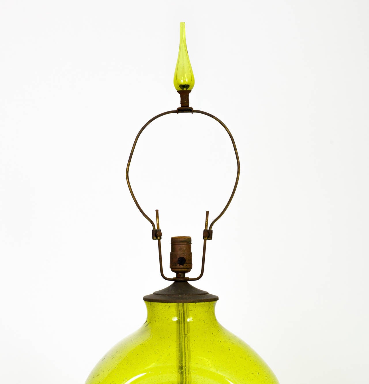 Bulbous table lamp with pinched sides executed in lime-colored blown glass and supported by a round, lacquered wood foot, designed by Wayne Husted for Blenko. Original, matching glass finial and adjustable harp included.

Dimensions: Height of
