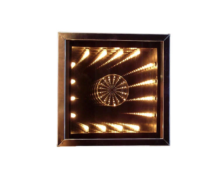 A fun, modestly-sized infinity mirror with a chrome frame, manufactured in California by Neo Art Inc., with an extra-trippy effect provided by the convex center. May be hung on the wall or displayed freestanding anywhere you desire some functional,