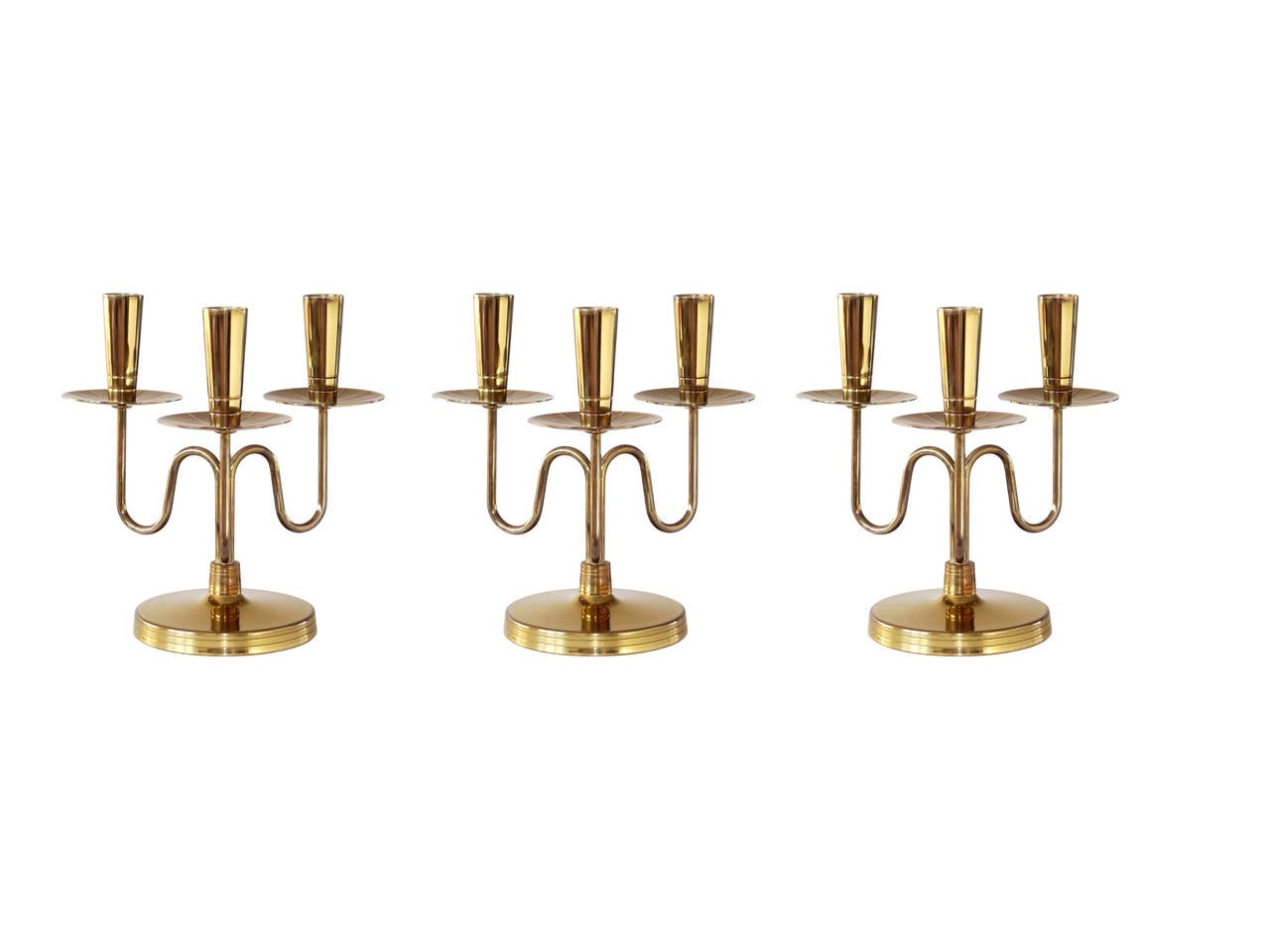 A set of three matching candleholders executed in lacquered solid brass by Tommi Parzinger for Dorlyn Silversmiths. Exceptional craftsmanship and classically modern. All original condition.

Professional re-lacquering and polishing available at