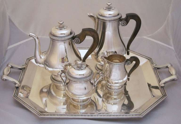 A handsome tea and coffee set by the celebrated French silver company, Christofle.

Includes handled tray and tea pot with hinged lid, coffee pot with hinged lid, sugar with removable lid and creamer.

Marked: Christofle - France, Chess Piece