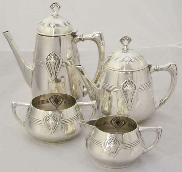 A handsome tea and coffee set by the celebrated German metal-smiths, WMF, featuring a stylish design that might appeal to collectors of Art Deco or Art Nouveau.

Includes tea pot with hinged lid, coffee pot with hinged lid, sugar, and