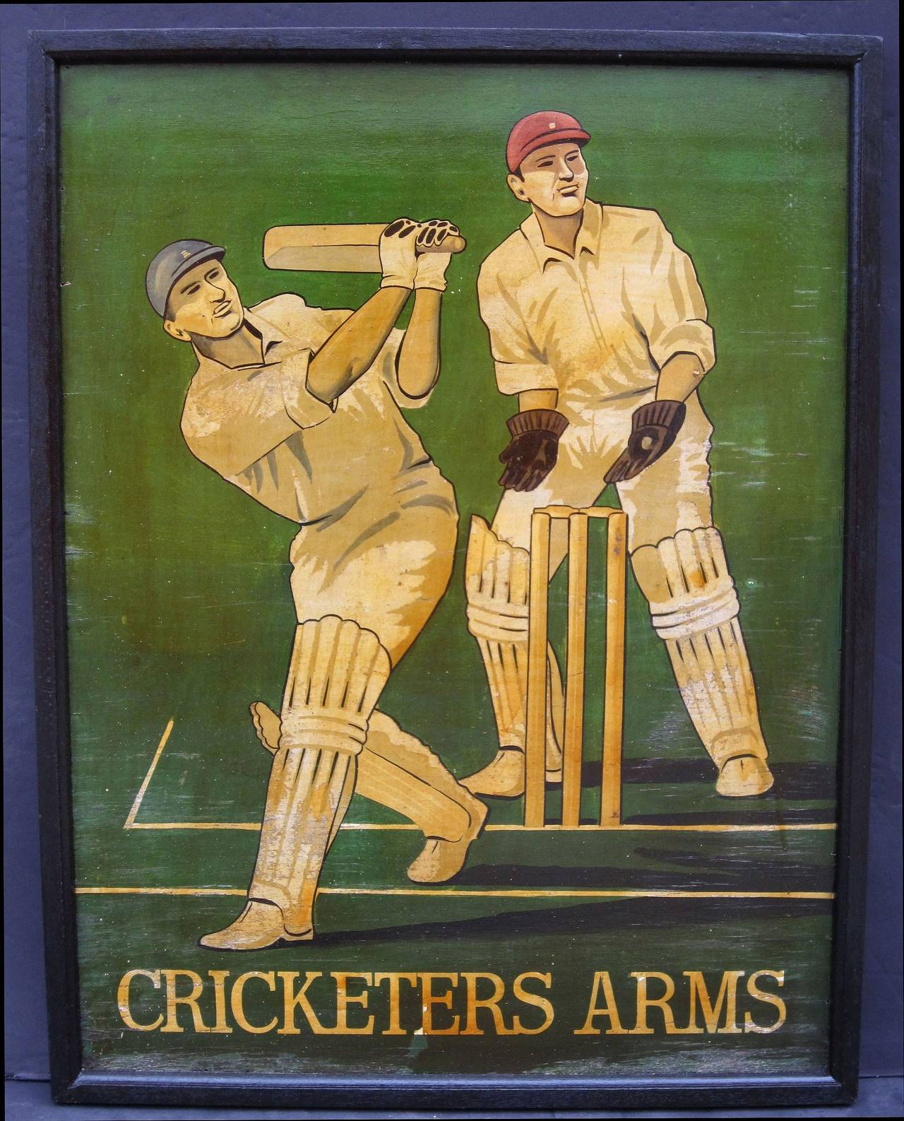 An authentic English pub sign (one-sided) featuring a painting of cricket players on a pitch, entitled: Cricketers Arms.

A very fine example of vintage advertising artwork, ready for display.
