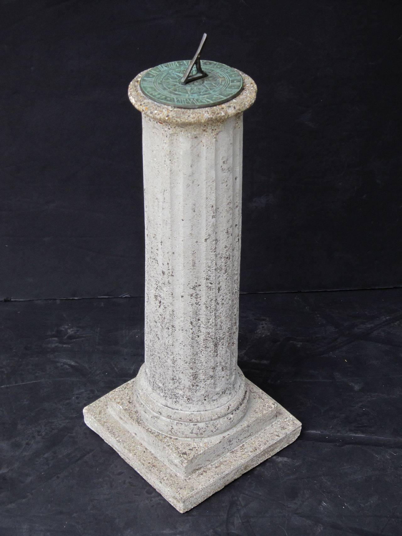 A Fine English garden column sundial of composition or garden stone featuring a bronze dial inscribed with Roman numerals, cardinal directions and the following quote: 