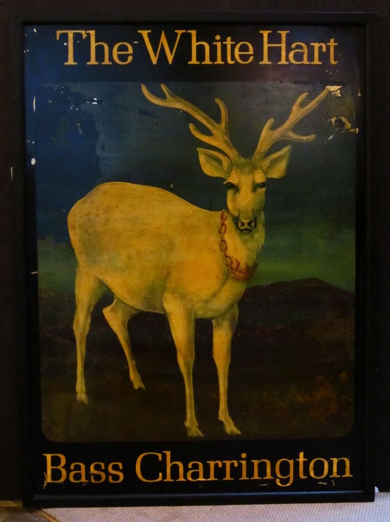 An authentic English pub sign (one-sided) featuring a painting of a white stag or deer with antler rack, wearing a chain round its neck, entitled: The White Hart (Bass Charrington)

Bass Charrington - a former brewing concern that was the merger