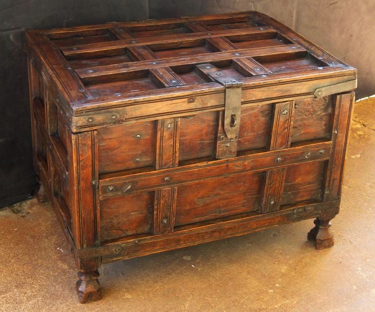 A handsome 19th c. iron-bound stick box or coffer from British Colonial India featuring a hinged top hatch with storage inside. The trunk with original ribbed iron fittings and standing on turned feet.

Traditionally used for patio storage in