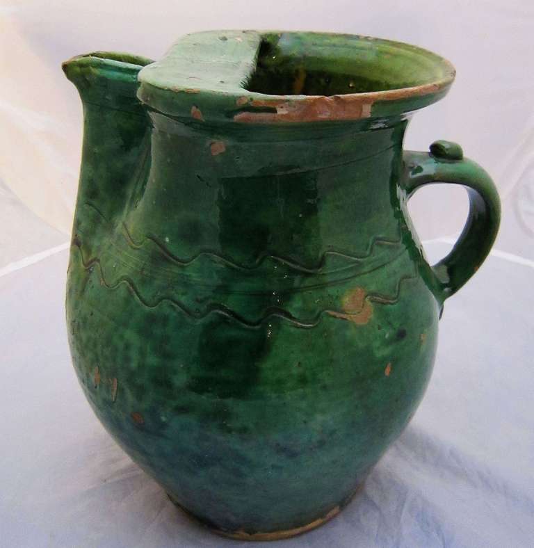 A rare form French jug, circa 1830, sometimes known as a pichet, and a Fine example of pottery from Southern France. Featuring a deep green glaze over earthenware with a zigzag pattern around the midriff.

Part of a collection of rare form jugs -