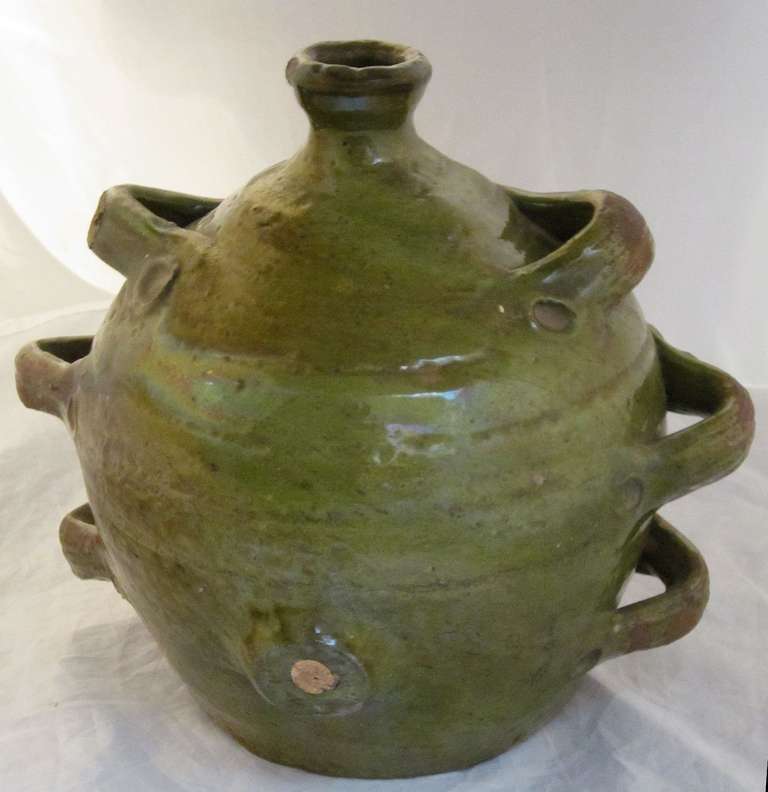 A 19th century rare form French jug sometimes known as a conscience and a fine example of pottery from Southern France. Featuring an olive green and colored glaze over earthenware.

Part of a collection of rare form jugs- see last photo.

Please