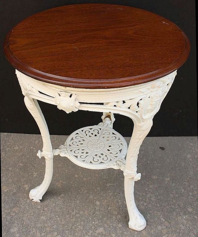 An English pub table featuring a moulded round top of mahogany attached to an undertier of cast iron with three cabriole legs showing cartouche cameos of Queen Victoria and decorative ornaments.<br />
<br />
Marked on base: Coalbrookdale No. 72,