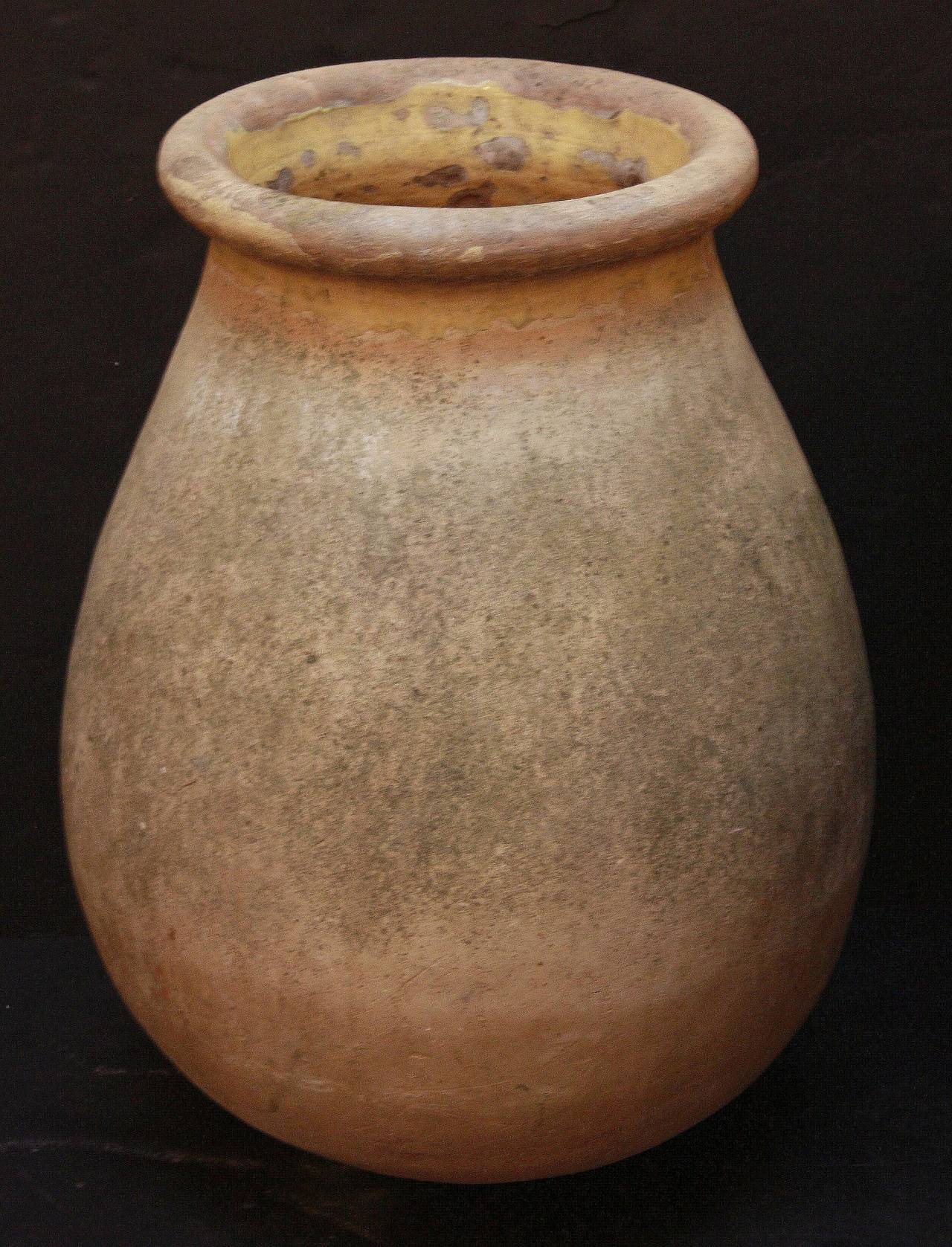 A handsome large French garden pot or oil jar from the Biot, Alpes-Maritimes, region - known as a pottery center from the 18th c. onward. 
Featuring a glazed rolled-edge top over a smooth, cylindrical body and functional as a garden ornament,
