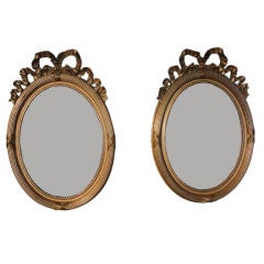 Pair of French Oval Gilt Mirrors with Ribbon Design