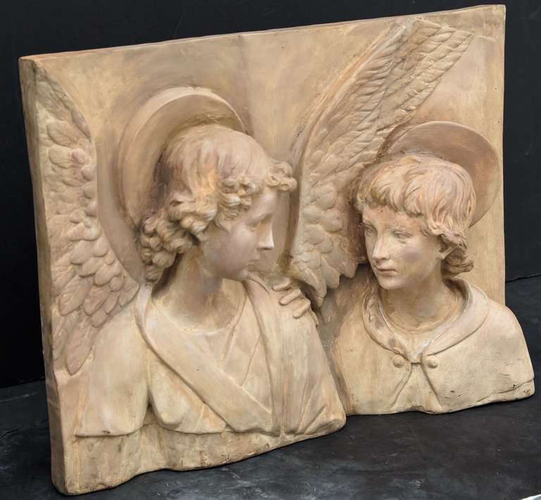 A beautiful Italian bas-relief plaque in terra cotta of two angels.
Each angel in religious costume with wings and halo.