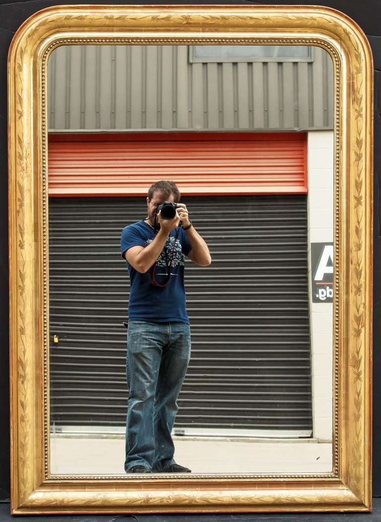 A handsome large French gilt mirror in the Louis Philippe style, featuring a lovely etched foliate design with beading around the circumference of the moulded frame.

Dimensions: H 55 1/2
