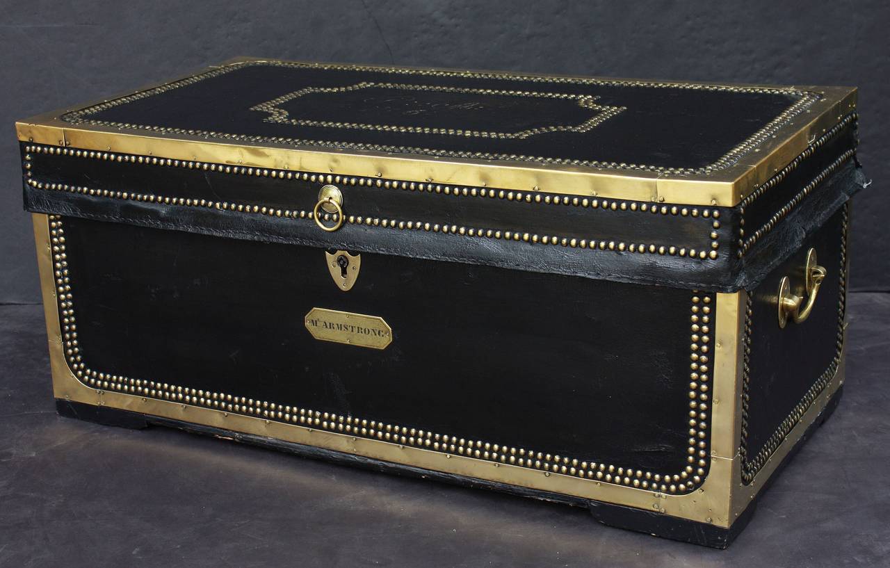 A handsome large British officer's military Campaign camphor trunk or chest of brass-bound and studded leather over camphor wood, c.1820. 
Manufactured by the Dutch East India Company for an officer to carry his kit on campaign. 
With original