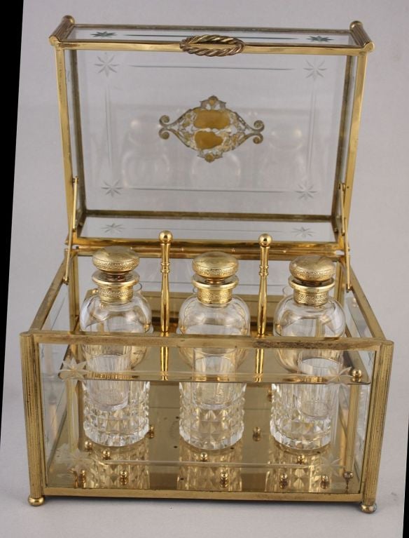 A decanter set of gilt dore bronze and etched crystal by the celebrated French crystal glass manufacturer, Baccarat.<br />
<br />
The box with fitted interior housing three gilt dore bronze and cut crytal decanters and six cordial glasses.<br