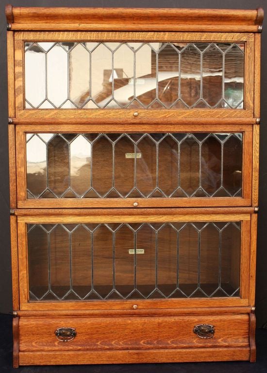 An English lawyer's or solicitor's stacking bookcase of oak and leaded glass by the celebrated furniture-makers, Globe-Wernicke.