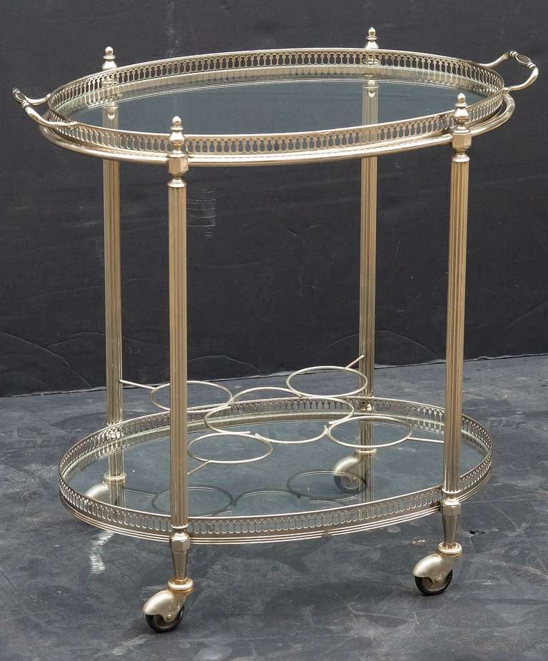 A vintage French oval bar cart or trolley in silver gilt and glass with pierced galleries, removable top tray, and bottle holders, on caster wheels. 

Perfect for use as a side or end table.