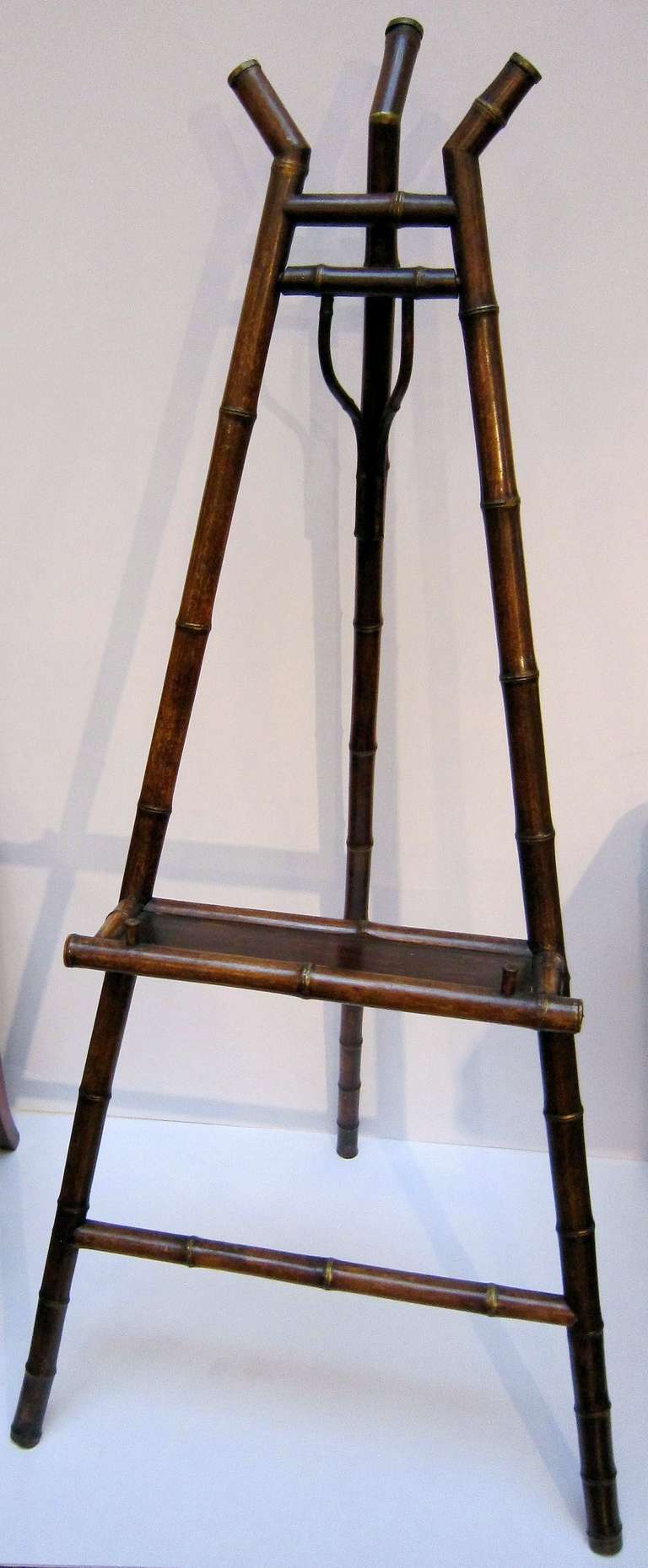 An English bamboo display easel featuring a handsomely patinated frame with fixed lacquer panel support tray.

Dimensions: H 64
