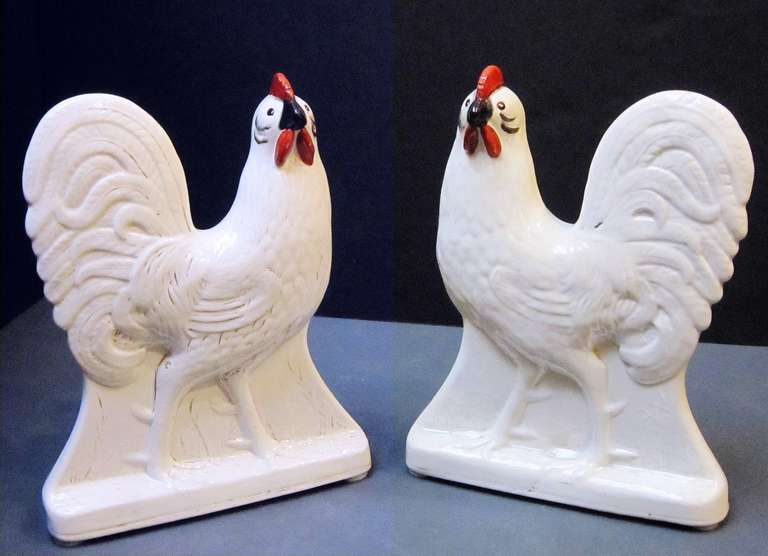 A handsome pair of large white-glazed cockerels or roosters from the 9th c. English potteries in Staffordshire, featuring an elegant design and hand-decorated faces.

Priced as a pair - $4950 the pair