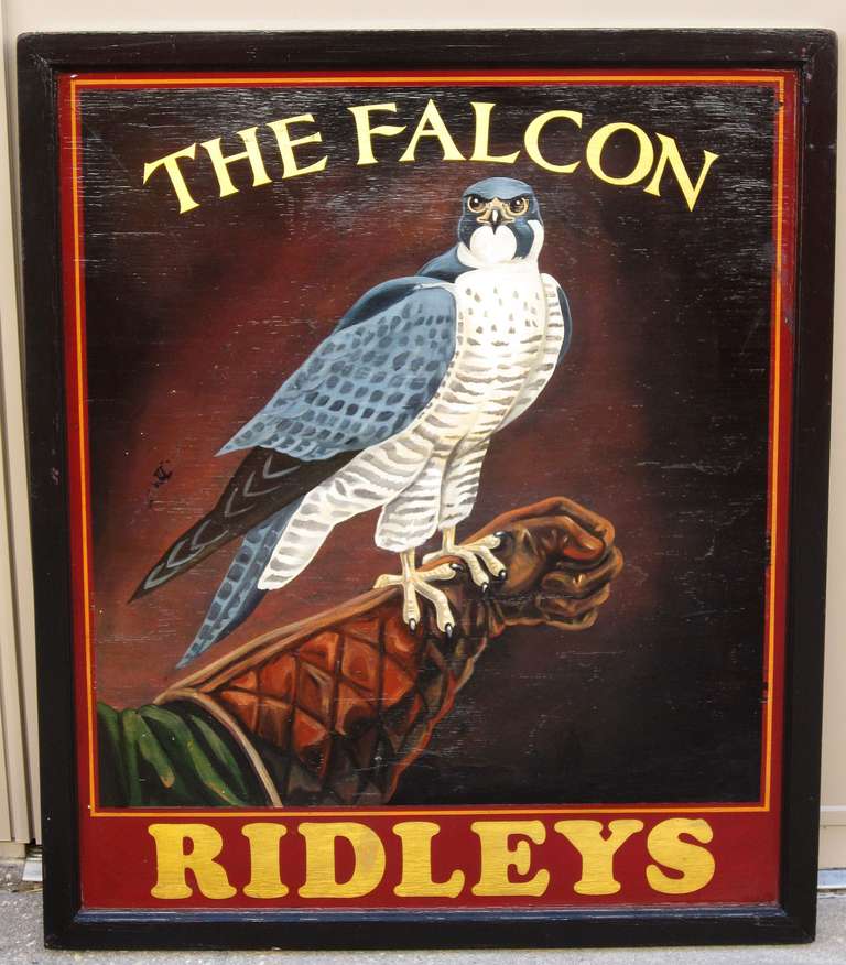 An authentic English pub sign (two-sided) featuring a scenic painting of a falcon on a falconer's gloved arm, entitled: The Falcon

Falconry is the hunting of wild quarry in its natural state and habitat by means of a trained bird of