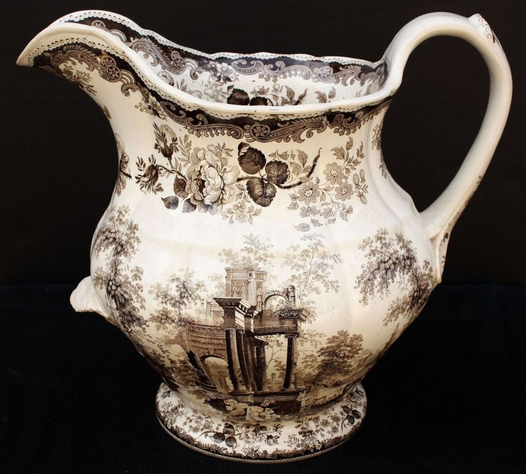 A large ironstone brown-and-white transfer-ware pitcher by the celebrated English pottery firm, Mason's (Charles James Mason & Co., Patent Ironstone Manufactory, Lane Delph, Staffordshire Potteries).<br />
<br />
Featuring a design of a Classical