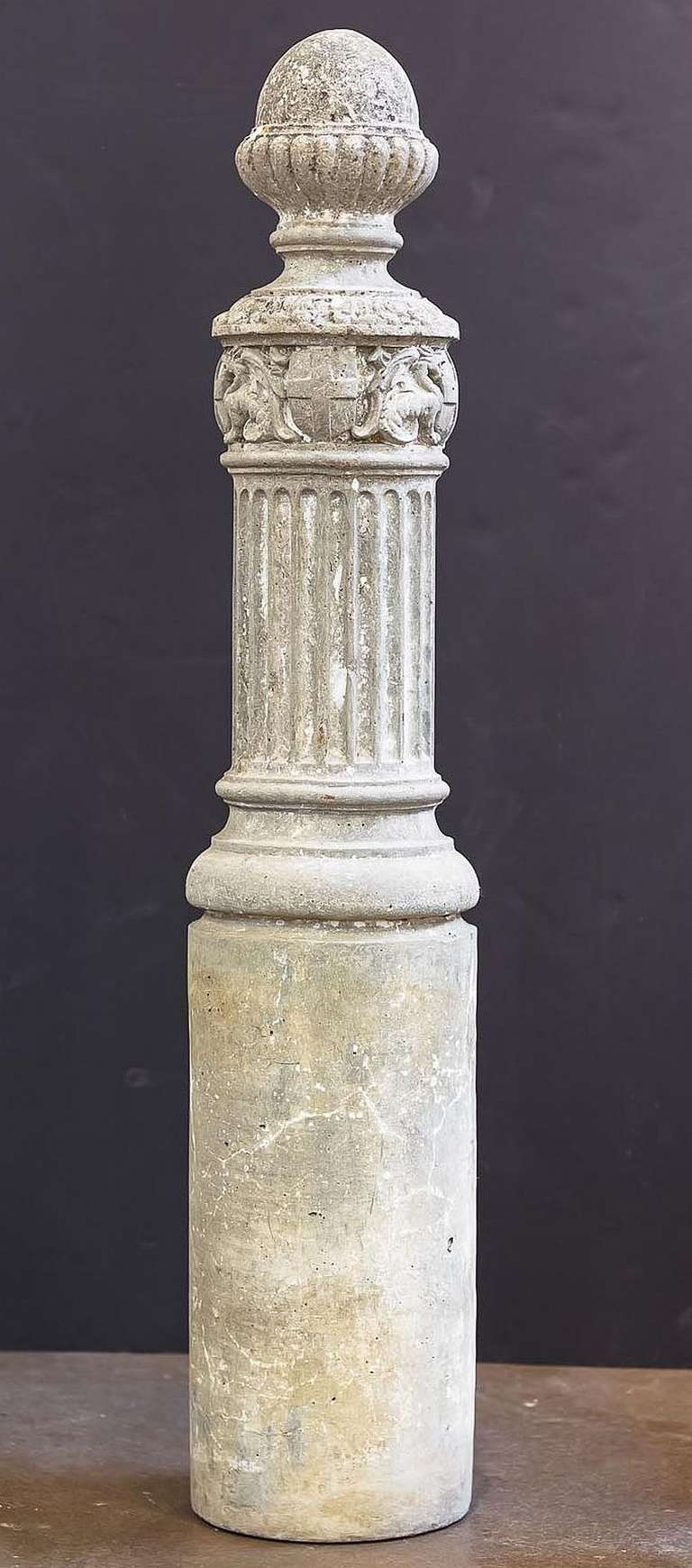 A large English garden stone column or pedestal designed for use a horse tethering post.