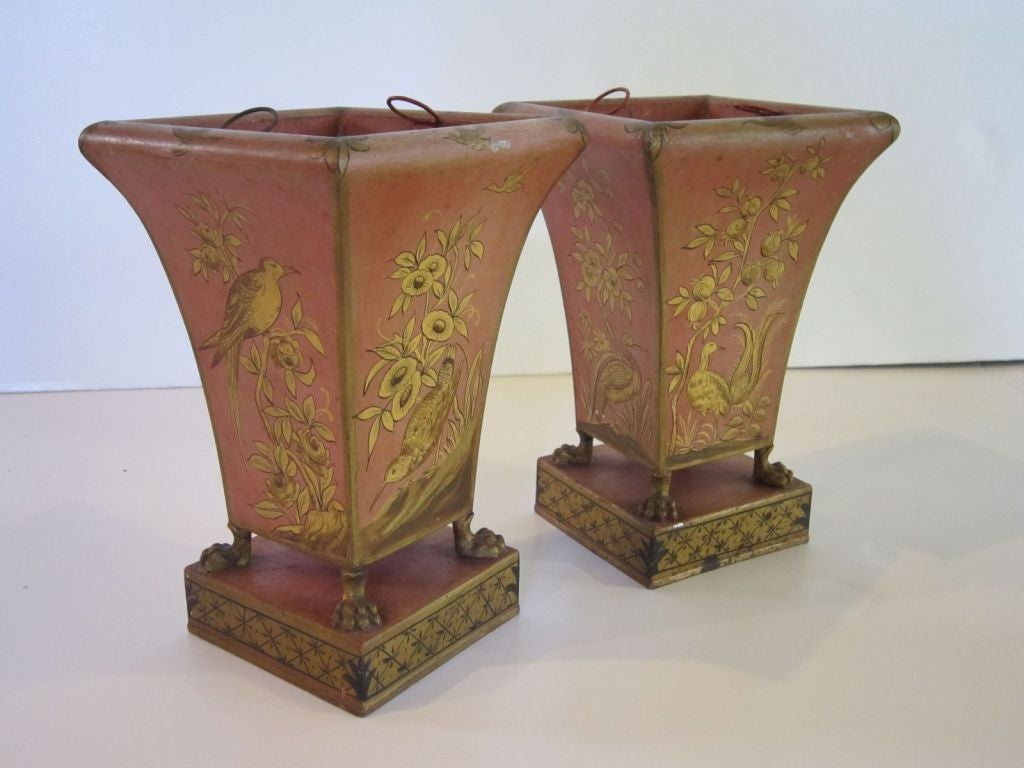 A lovely pair of English tole planters - each featuring a design of birds in gilt around the circumference, on raised claw feet attached to plinth pedestal. With removable liners.<br />
<br />
Sold as a pair.<br />
<br />
Perfect in a garden