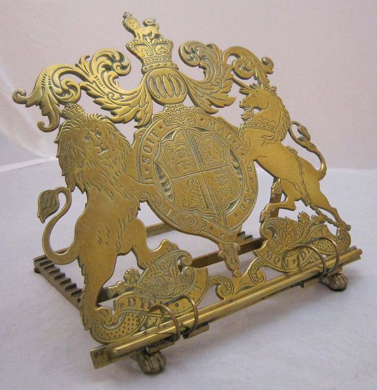 A handsome desk-top adjustable book rest of book stand of brass, c.1870, featuring a design of the British royal coat of arms or royal crest. 

The coat features both the motto of English monarchs, Dieu Et Mon Droit (God and my right), and the