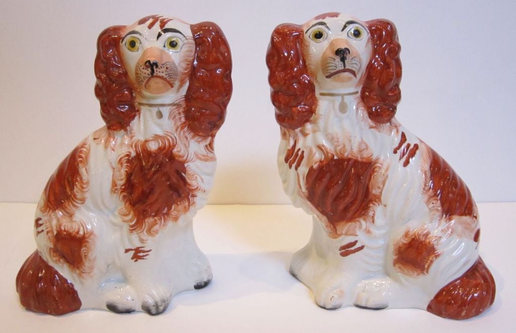 Two handsome pairs of 19th c. English King Charles spaniels from the Staffordshire Potteries. 

This selection has been priced as two separate pairs.
The listed price is for the pair of smaller dogs.

Also known as comforter dogs, each pair is