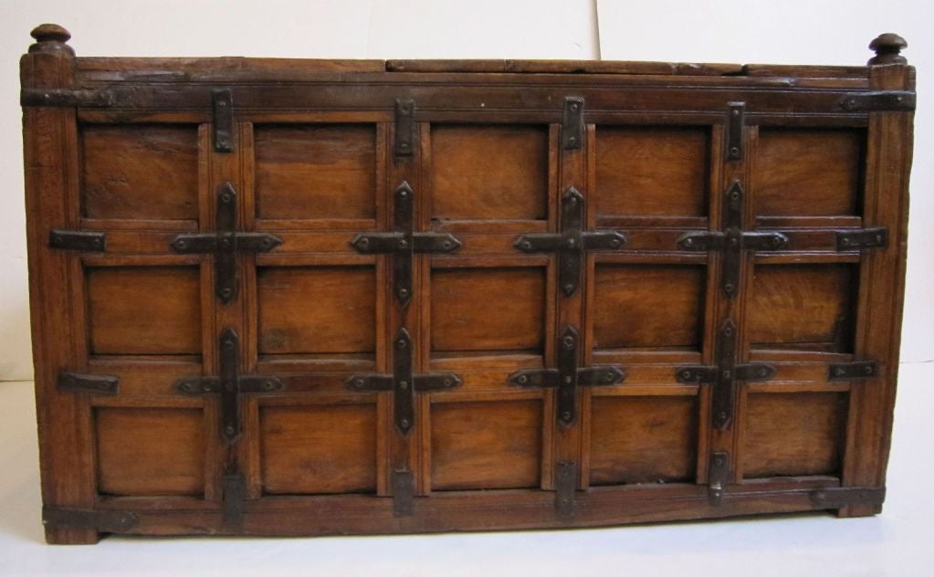 A handsome 19th c. iron-bound stick box or coffer from British Colonial India featuring a small removable top hatch which allows for storage inside and decorative finials on each corner. The trunk with original ribbed iron fittings. <br />
<br