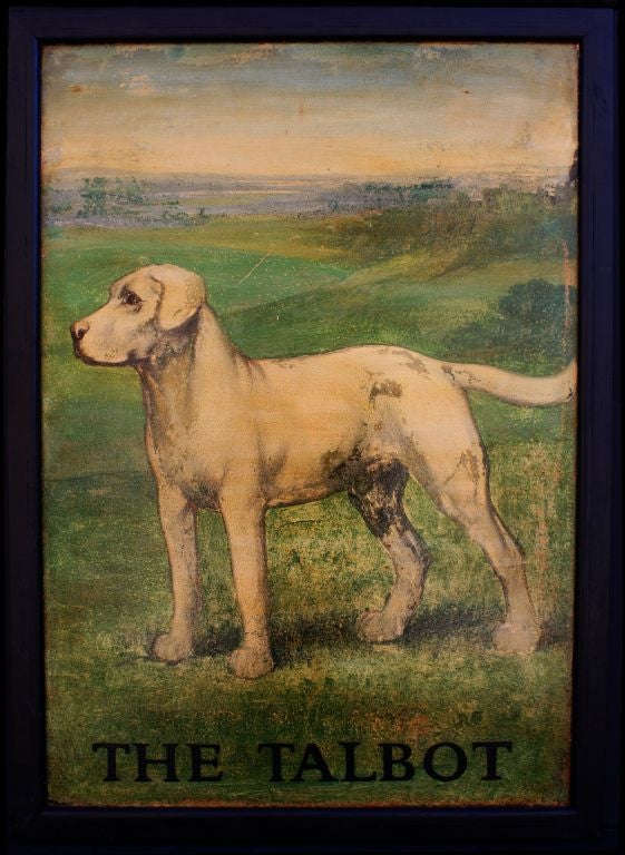 An authentic English pub sign (one-sided) featuring a portrait of a white dog on a green field, entitled: The Talbot<br />
<br />
The talbot is an extinct snow-white hunting dog, with a keen sense of smell and such a large stature that it was