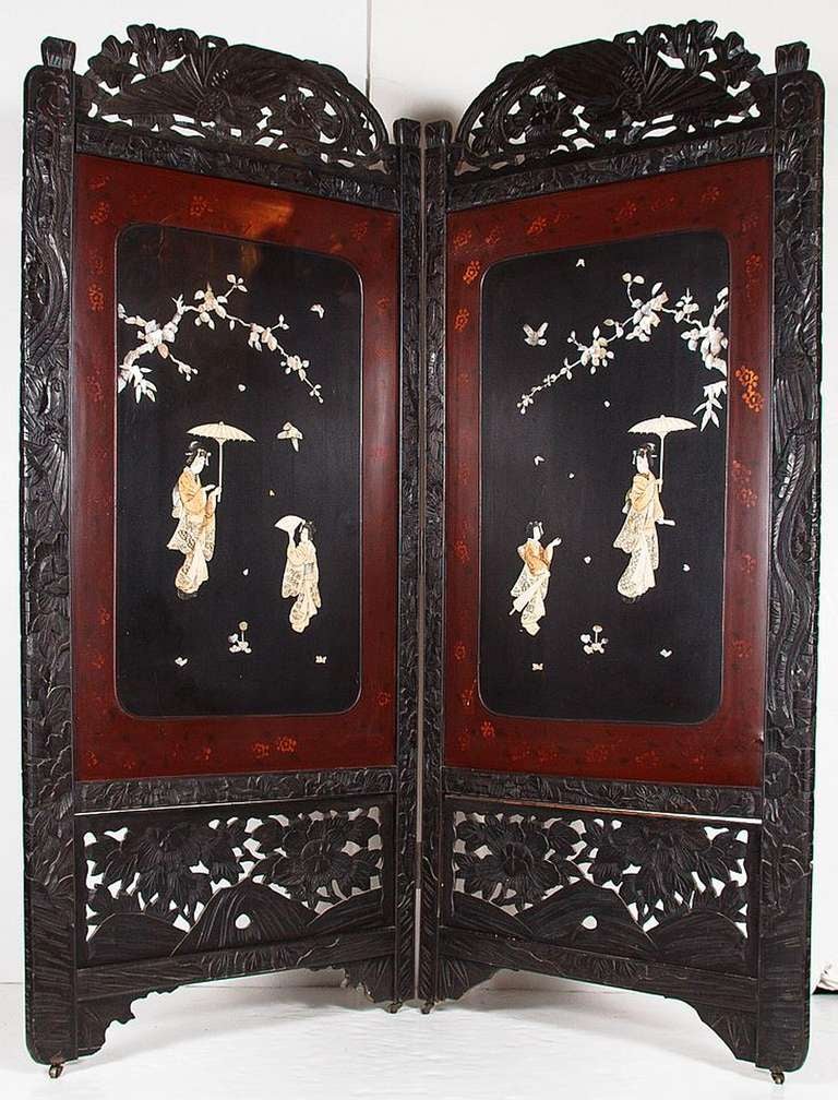 A 19th century two-fold lacquered screen featuring Japan-laquered front and back on rolling brass casters. The obverse side having a Japanese (or chinoiserie) relief design of geisha girls with fans and foliate design in mother-of-pearl. With