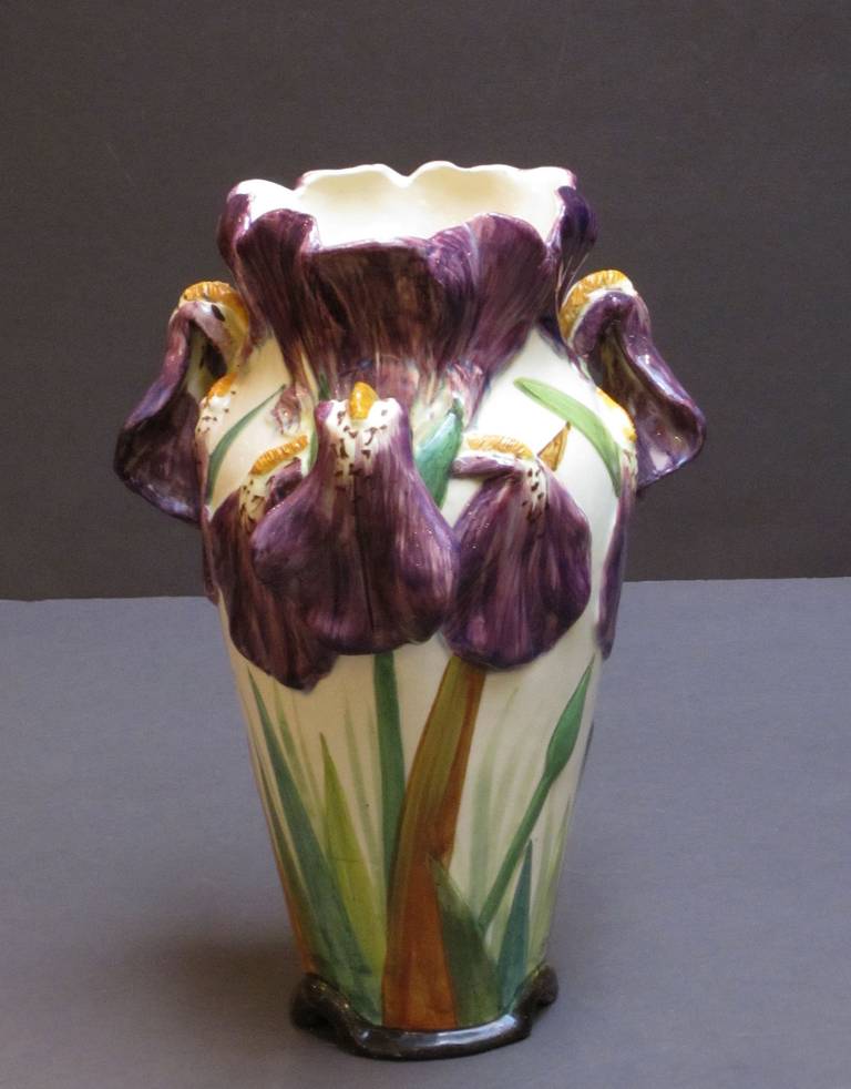 A lovely pair of hand-painted Majolica vases featuring a relief design of irises by the celebrated French pottery firm, Massier.

Signed on the base: Delphin Massier - Vallauris - A.M.

Pictured on P.153 Massier- L'Introduction De La Ceramique