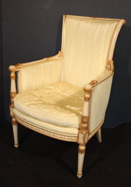 A beautiful Venetian armchair featuring arms, sides and legs of painted turned wood with gilt accents and silk upholstered back and seat.
Measures:
Back:- H: 39