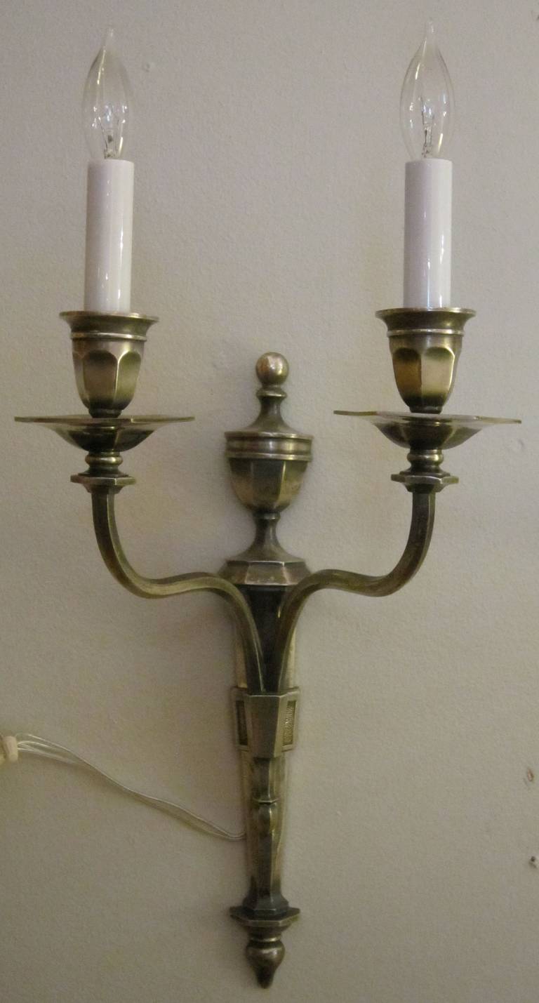 A handsome pair of English wall lights or sconces, each featuring an Adam-style mount with two-arm serpentine candelabra of burnished pewter.

Priced as a pair: $2695 pair.