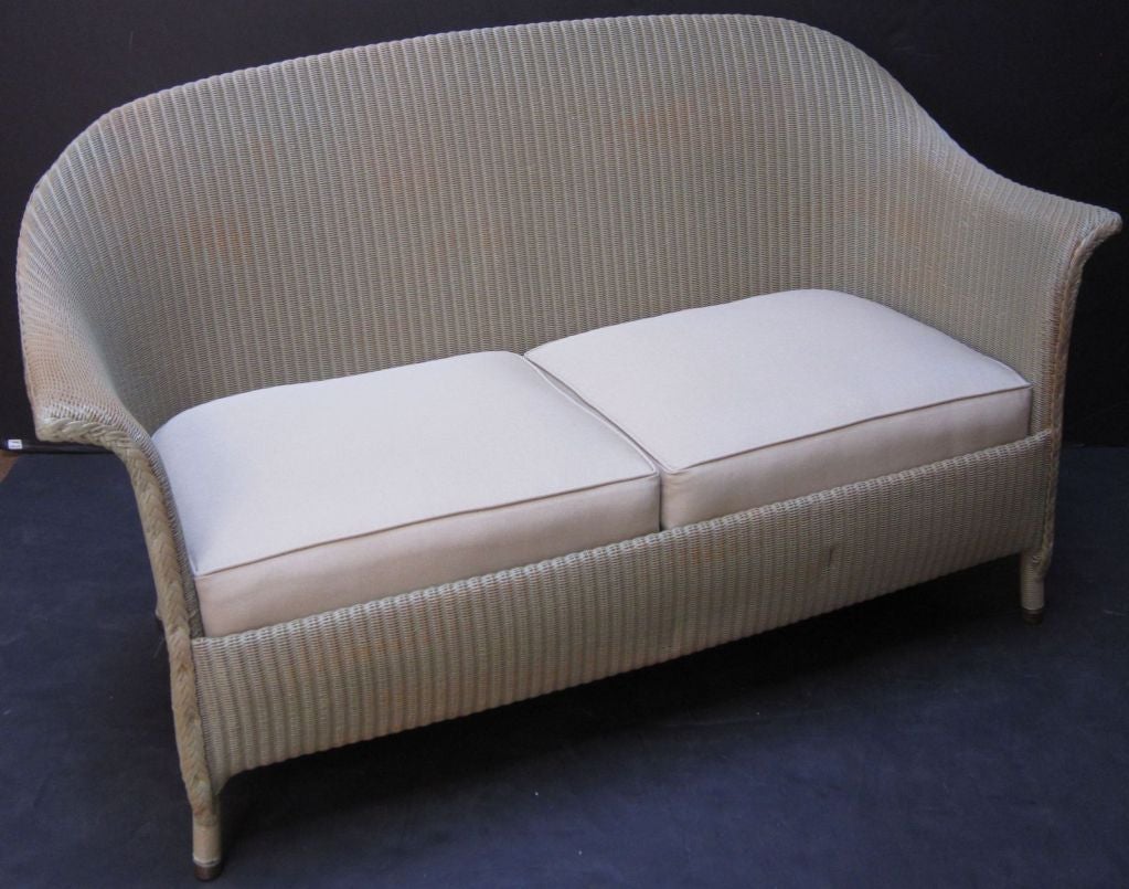 A Lloyd Loom sofa, synonymous with classic English style.
Perfect for the Garden Room or Conservatory, this sofa features the vintage look and comfort one only finds in the original, pre-War series. A flowing, serpentine back of woven wicker and