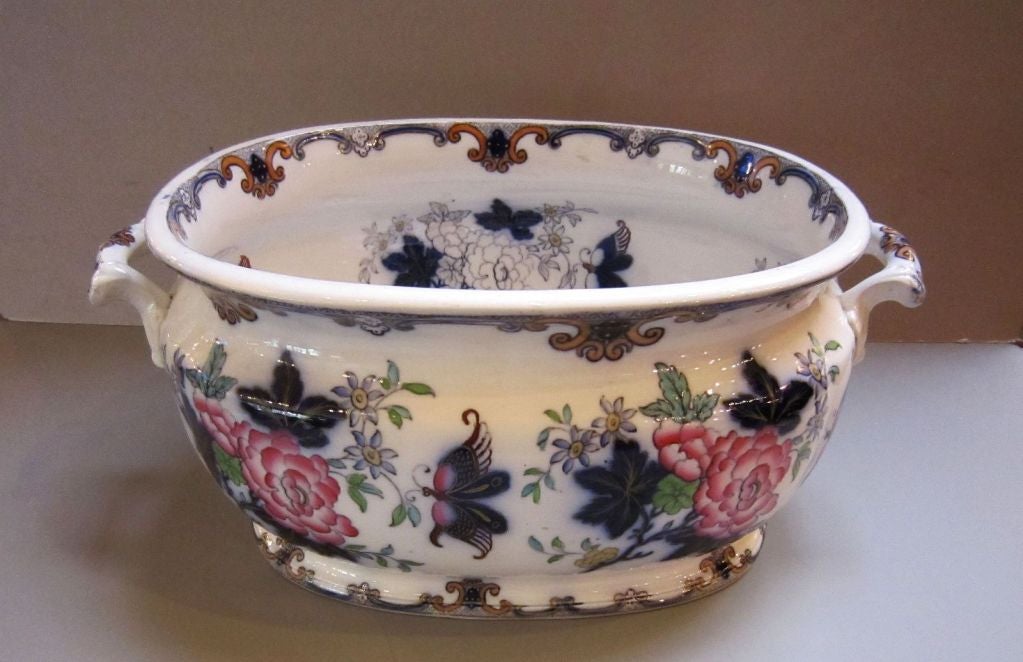 A beautiful ironstone footbath in the Poonah pattern by the celebrated English pottery firm, Charles Meigh, circa 1835-1849, featuring a polychrome design of flowers and butterflies on the exterior and interior. Perfect as a centerpiece display or