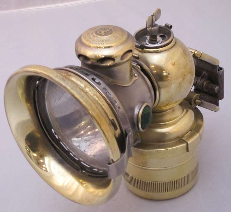 An early English brass bicycle lamp by Joseph Lucas, Ltd. Birmingham - This model known as the No.153 Lucas Calcia Toura. 

The chimney is marked: Lucas - Calcia Toura.
The Joseph Lucas Company in Birmingham was established in 1875.

A carbide lamp,