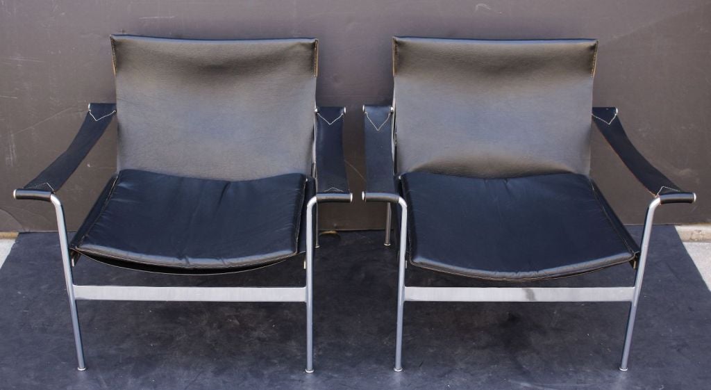 A pair of stylish, comfortable period modern lounge armchairs (or easy chairs) by the German designer, Hans Konecke of chromed steel and stitched black leather. Each chair with removable cushion.

Priced for individual sale: $2950 each