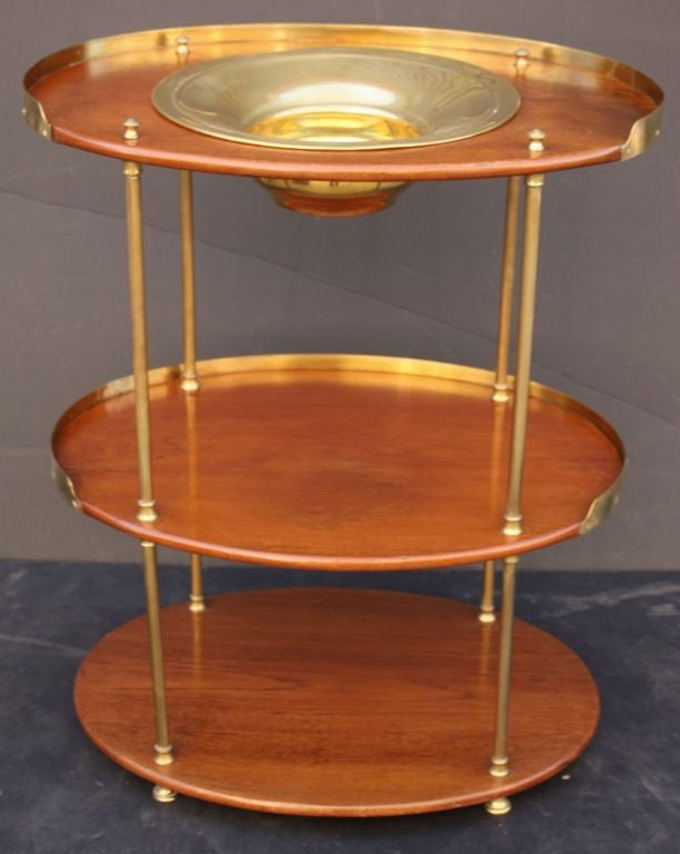 A handsome 19th Century British military officer's campaign wash stand of teak and brass, featuring three oval tiers adjoined by brass supports, with brass wash bowl.

Makes an excellent bar or stand for cocktails.

Campaign-era trunks and