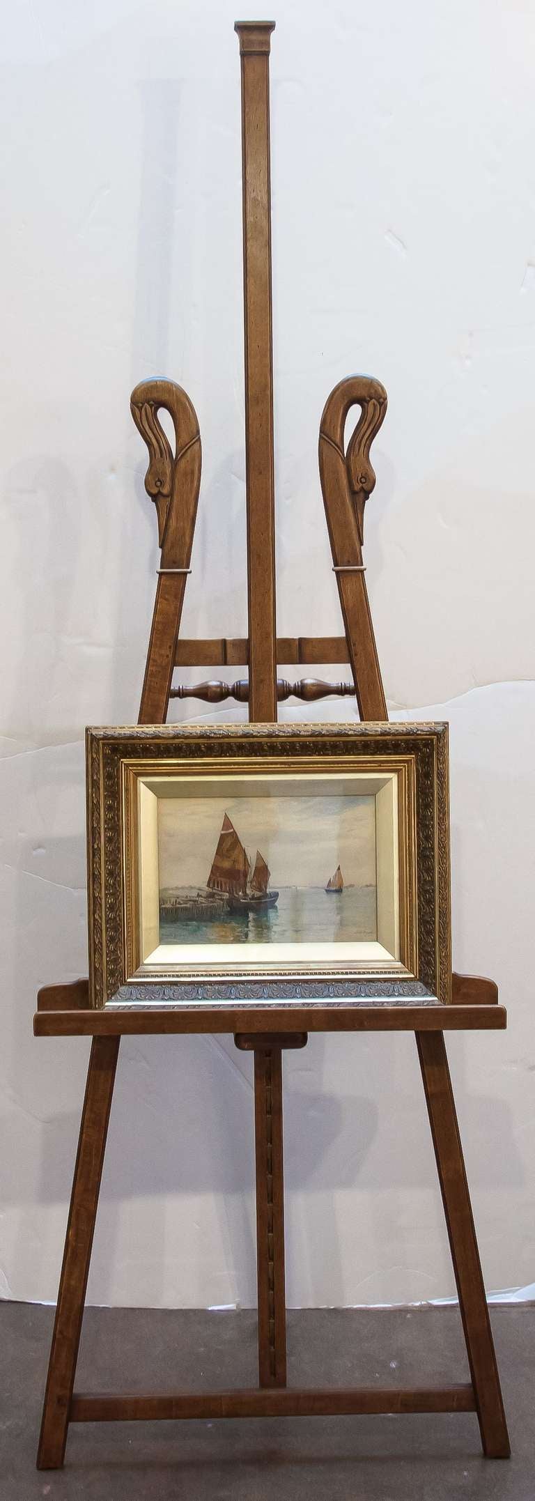 A large French artist's or painter's display easel of walnut, featuring a swan's neck design and nice turnings and mouldings.
Adjustable to several heights with brass locking hardware.