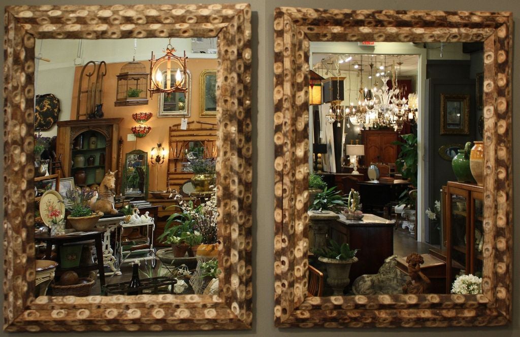A pair of English oyster stick wall mirrors featuring a canted frame of oyster stick wood (used in the sea when harvesting oysters) around mirrored glass.

Priced individually: $2895 each