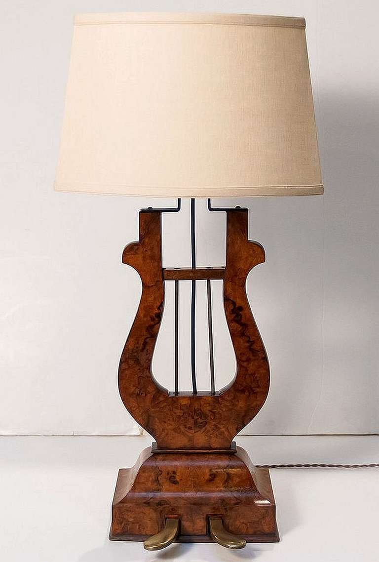 A handsome English lyre-shaped lamp of burr walnut with shade featuring a design crafted from the foot pedal of an antique piano.